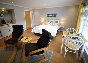 Medina Accommodation in Portree contains a King Size Double Bed and Private Seating Area
